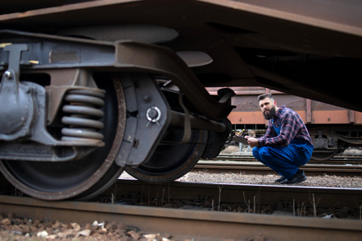 Creds: FreePik - Railroad worker inspecting wheels and brakes of the freight train after Siemens Mobility story