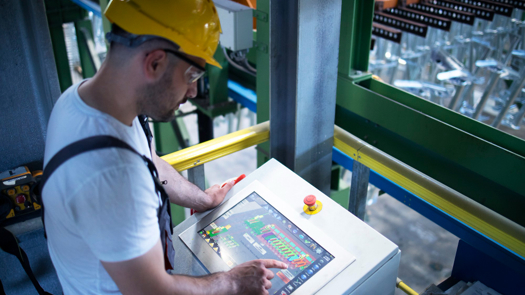 Creds: ABI Research - Man working on a factory plant